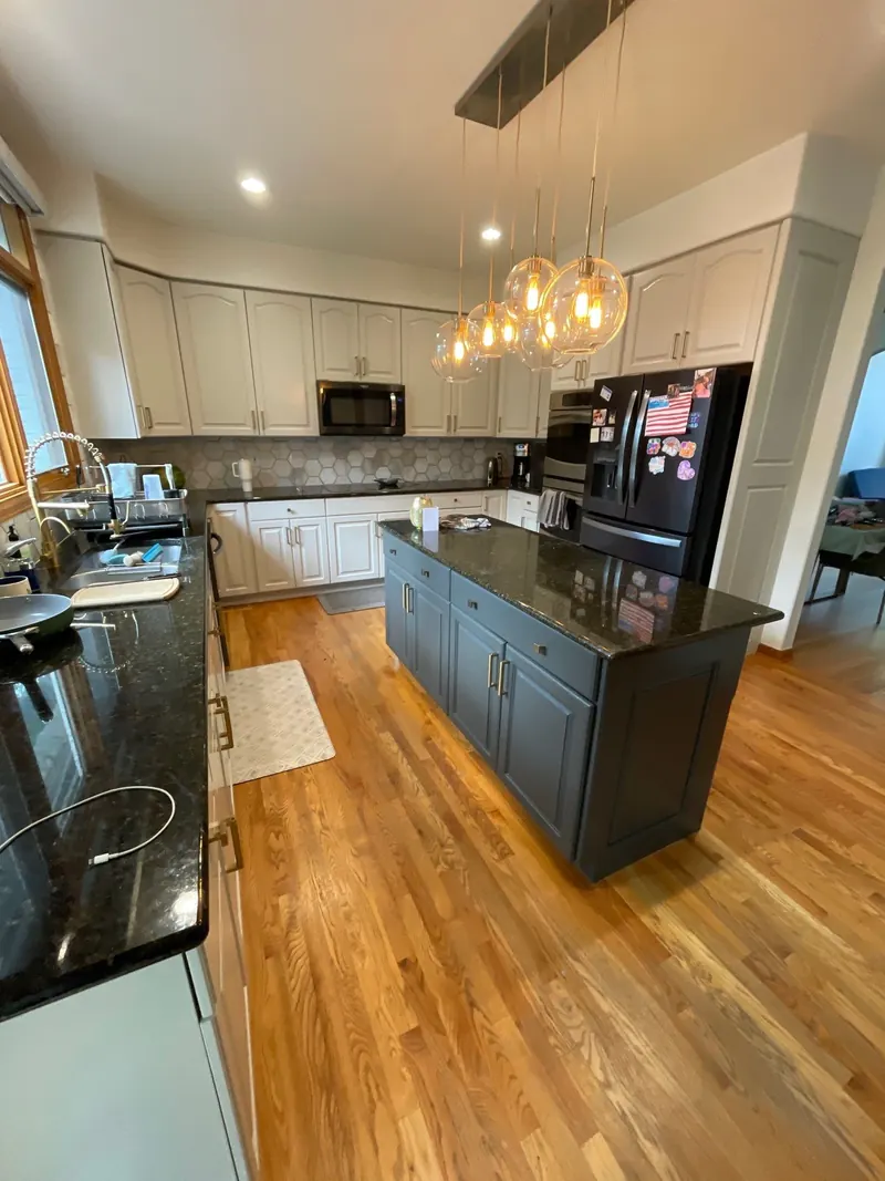 Repainted gray kitchen cabinets with stainless refrigerator